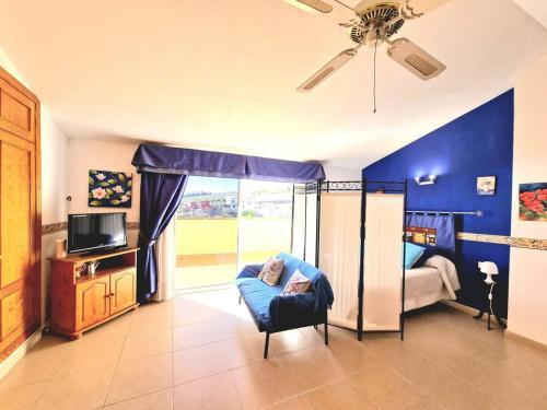 a room with a bedroom with a bed and a window at Luis Estudio Adeje Tenerife Sur by HRTenerife Net in Adeje