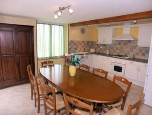 a kitchen with a large wooden table and chairs at Gite st cirq Lapopie piscine vue imprenable in Tour-de-Faure