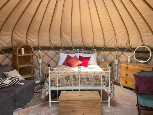 a bedroom with a bed in a yurt at Puckaster Cove Garden Yurt in Niton