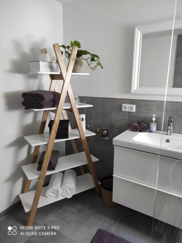 ein Badezimmer mit einer Leiter mit Handtüchern und einem Waschbecken in der Unterkunft Ferienwohnung Daheim in Achstetten