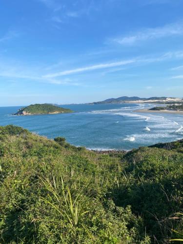 Blick auf den Ozean von der Spitze eines Hügels in der Unterkunft Sapê Guest Hotel in Praia do Rosa