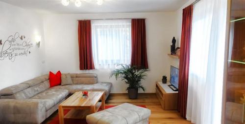 a living room with a couch and a table at Ferienwohnung Natural A in Gerlosberg