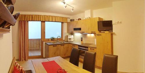 a kitchen with a table and a kitchen with a dining room at Ferienwohnung Natural A in Gerlosberg