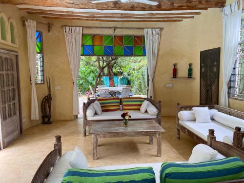 a living room with a couch and a table at Seaside Villa 1 & Seaside Villa 2 at 'Tamani' in Diani Beach