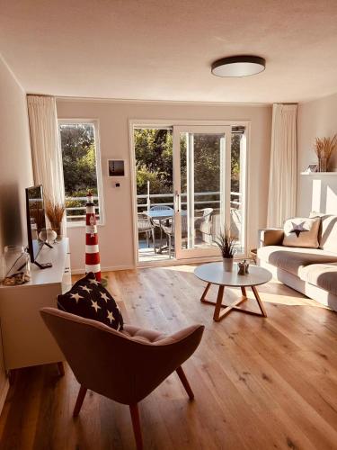 a living room with a couch and a table at Westend Amelander Kaap 85 in Hollum