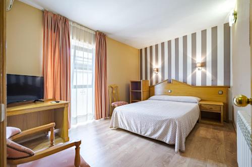 Postel nebo postele na pokoji v ubytování Hostal Don Juan
