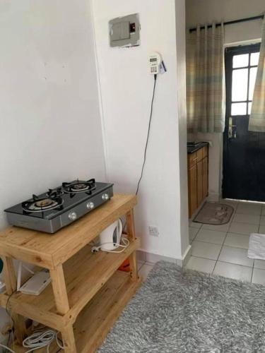 a kitchen with a stove on a wooden table at Lux Suites Rio Vista Executive Studio Apartments in Makandara