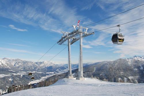 a ski lift on top of a snow covered mountain at Apartments Haufhof , Haus im Ennstal bei Schladming in Haus im Ennstal