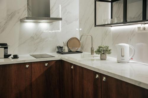 a kitchen with a sink and a counter top at Athena City Apartment in Athens