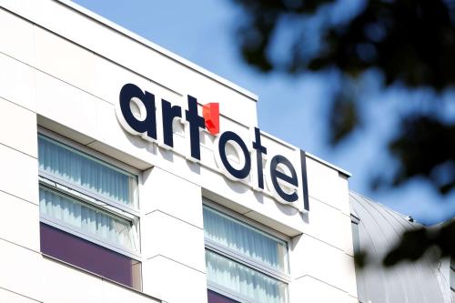 a sign on the side of a office building at art'otel berlin mitte, Powered by Radisson Hotels in Berlin