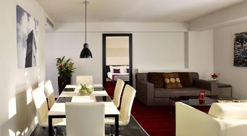 a living room with a table and a couch at Park Plaza Leeds in Leeds