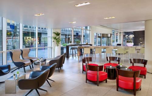 a restaurant with chairs and tables and a bar at Park Plaza Nottingham in Nottingham