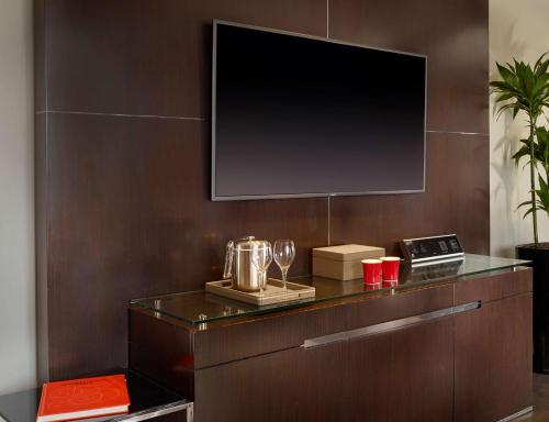 a tv on a wall in a room with a table at Park Plaza London Westminster Bridge in London