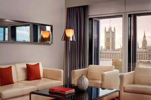 a living room with a view of the london skyline at Park Plaza London Westminster Bridge in London