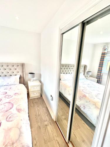 a bedroom with a mirror and a bed at Paradise on earth in Garthamlock