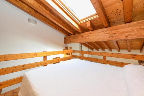 a bedroom with a bed in a wooden room at Appartamento in Piazza in Moniga
