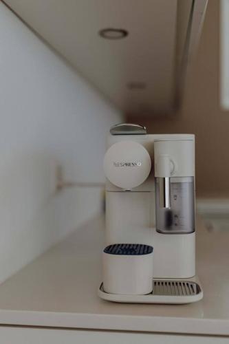 a coffee maker on a counter in a room at Stunning and Modern House On The Lake in Quarten