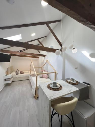 a room with a table and a bed in the background at Suites Chic Star in Herencia