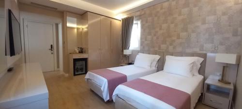 a hotel room with two beds and a fireplace at Villa No 44 in Darıca