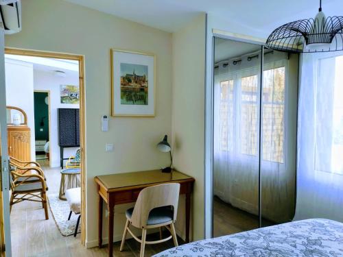 a bedroom with a desk and a table and chairs at La Waide in Amiens