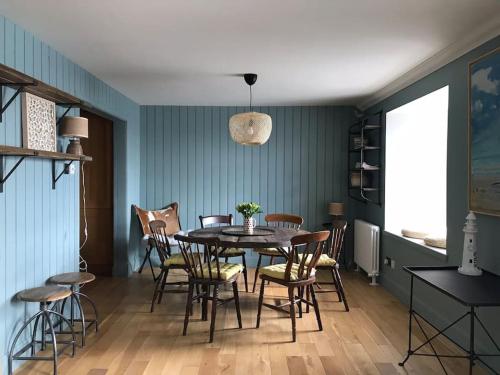 a dining room with a table and chairs at Harbour Side, Luxury, Twin Level Loft in Burghead