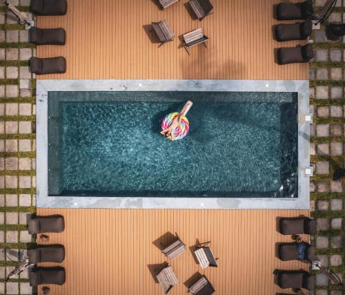 an overhead view of a swimming pool with a banana in the water at LalaGalu - Beachfront EcoCabins in Diani Beach
