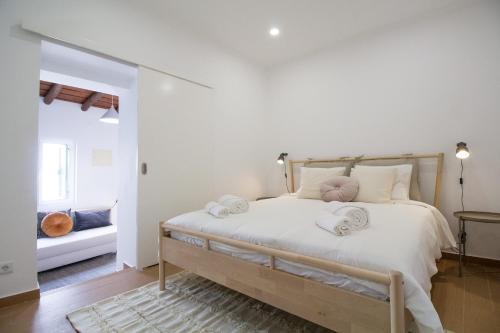 een slaapkamer met een bed met handdoeken erop bij Comfortable getaway in Medieval Castro Marim in Castro Marim