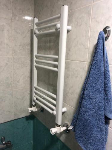 a shower stall with a blue towel on a wall at Ashtarak-2 LUX Apartment in Ashtarak