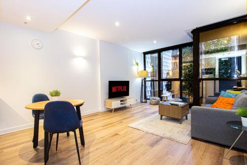 a living room with a table and a couch at Stay Like Home in Melbourne