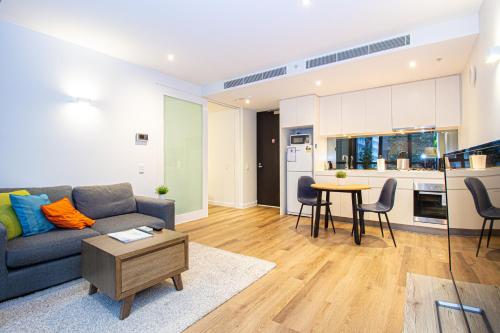 a living room with a couch and a table at Stay Like Home in Melbourne