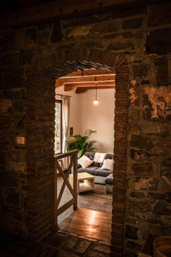 a living room with a brick wall and a couch at Holiday Home GaMaJaMa in Dobravlje