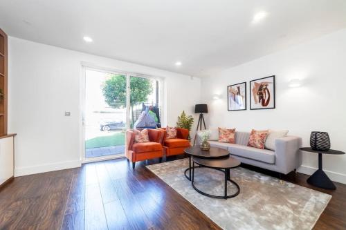 a living room with a couch and a table at Central 4BDR home wgarden & parking in London