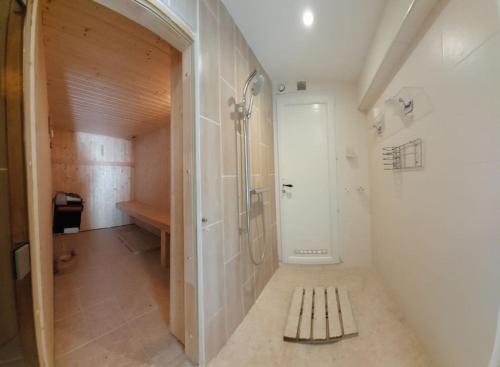 a bathroom with a shower and a bench in it at Dans villa spa hammam sauna piscine, 5 chambres in Juan-les-Pins