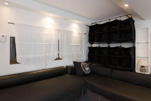 a couch in a room with a window and curtains at Dans villa spa hammam sauna piscine, 5 chambres in Juan-les-Pins