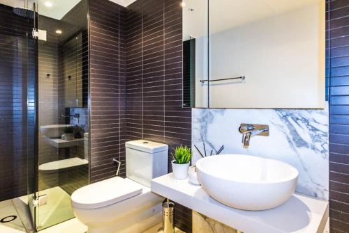a bathroom with a sink and a toilet at Stay Like Home in Melbourne