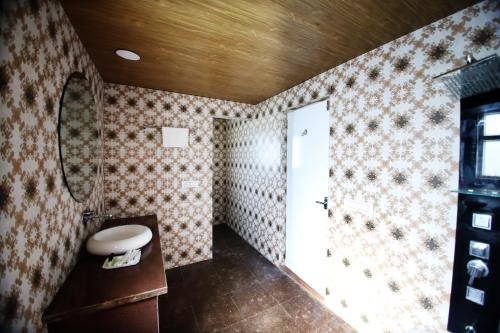 a bathroom with a sink and a toilet in a room at Virat Resorts, Sariska Rajasthan in Bairāt