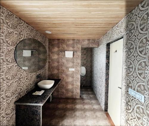 a bathroom with a sink and a mirror at Virat Resorts, Sariska Rajasthan in Bairāt