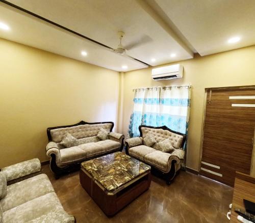 a living room with two couches and a coffee table at Virat Resorts, Sariska Rajasthan in Bairāt