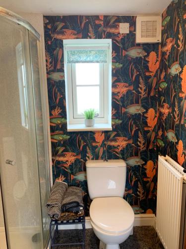 a bathroom with a toilet and a window at Farmhouse studio near Shrewsbury in Shrewsbury
