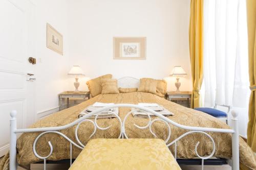 a bedroom with a bed with two chairs at Apartments Center Colmar in Colmar