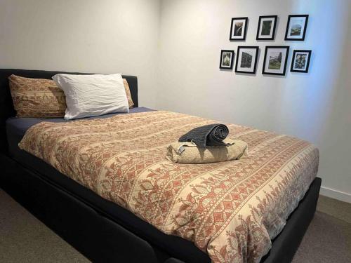 a bed with a comforter and a pillow on it at City-view High Rise 2BR Apt w/Pool, Sauna Gym, Library near Southern Cross Station Melbourne CBD in Melbourne