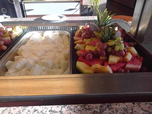 a tray of different types of food on a counter at Sunny Days Hotel in Ixia