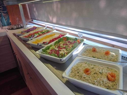 a buffet line with trays of different types of food at Sunny Days Hotel in Ixia