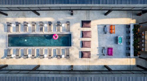 an overhead view of a pool with chaise lounge chairs at Boxo Diani - Unique Beach Front Container Eco-Hotel in Diani Beach