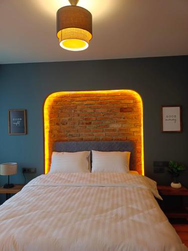 a bedroom with a large bed with a brick wall at Karaköy in Karaköy Hotel in Istanbul