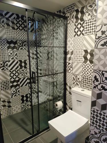 a bathroom with a shower and a toilet and tiles at Karaköy in Karaköy Hotel in Istanbul