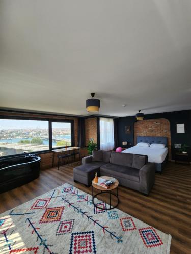 a bedroom with a bed and a couch in a room at Karaköy in Karaköy Hotel in Istanbul