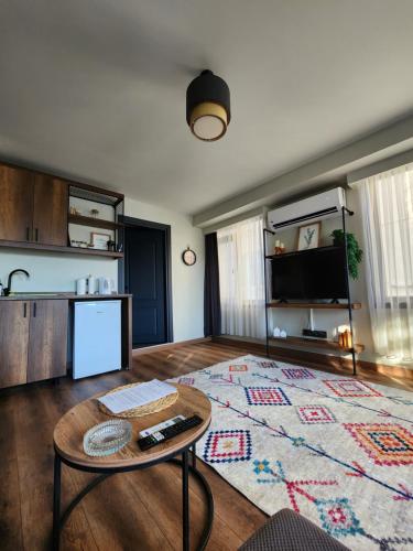 a living room with a table and a kitchen at Karaköy in Karaköy Hotel in Istanbul