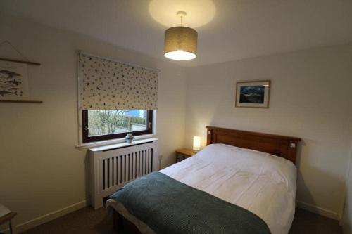 a bedroom with a bed and a window at 16 Station Square in Saint Marys