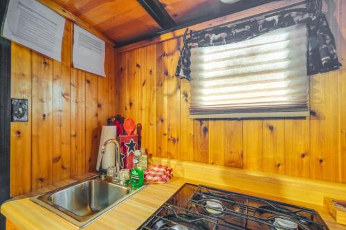 a kitchen with a sink and a window at Sevierville Studio Cabin Rental with Private Hot Tub in Sevierville
